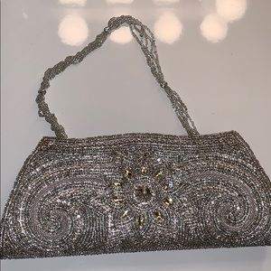 Ornate silver beaded clutch with beaded chain